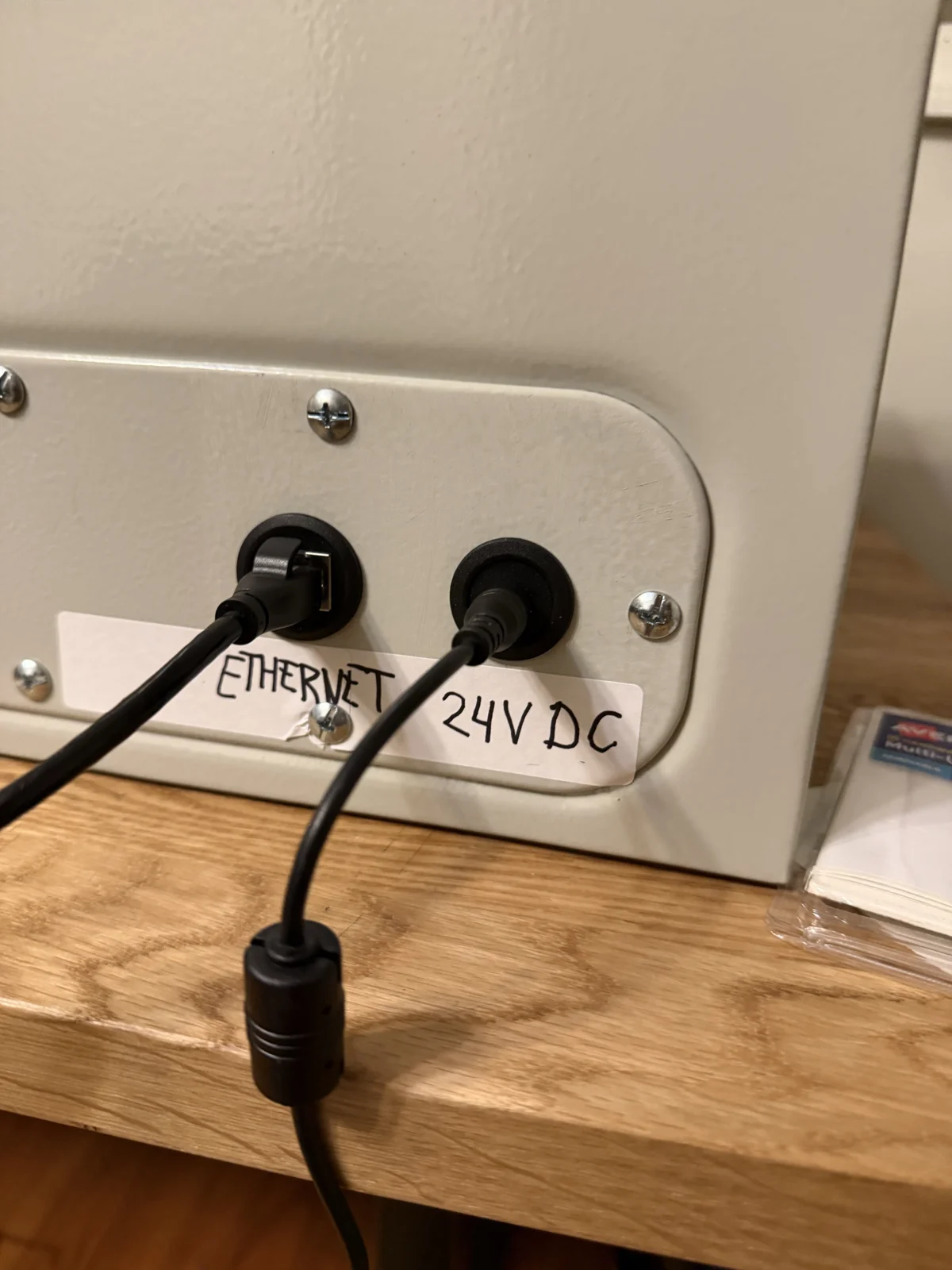 Labeled Ethernet and 24 V DC sockets under the cabinet