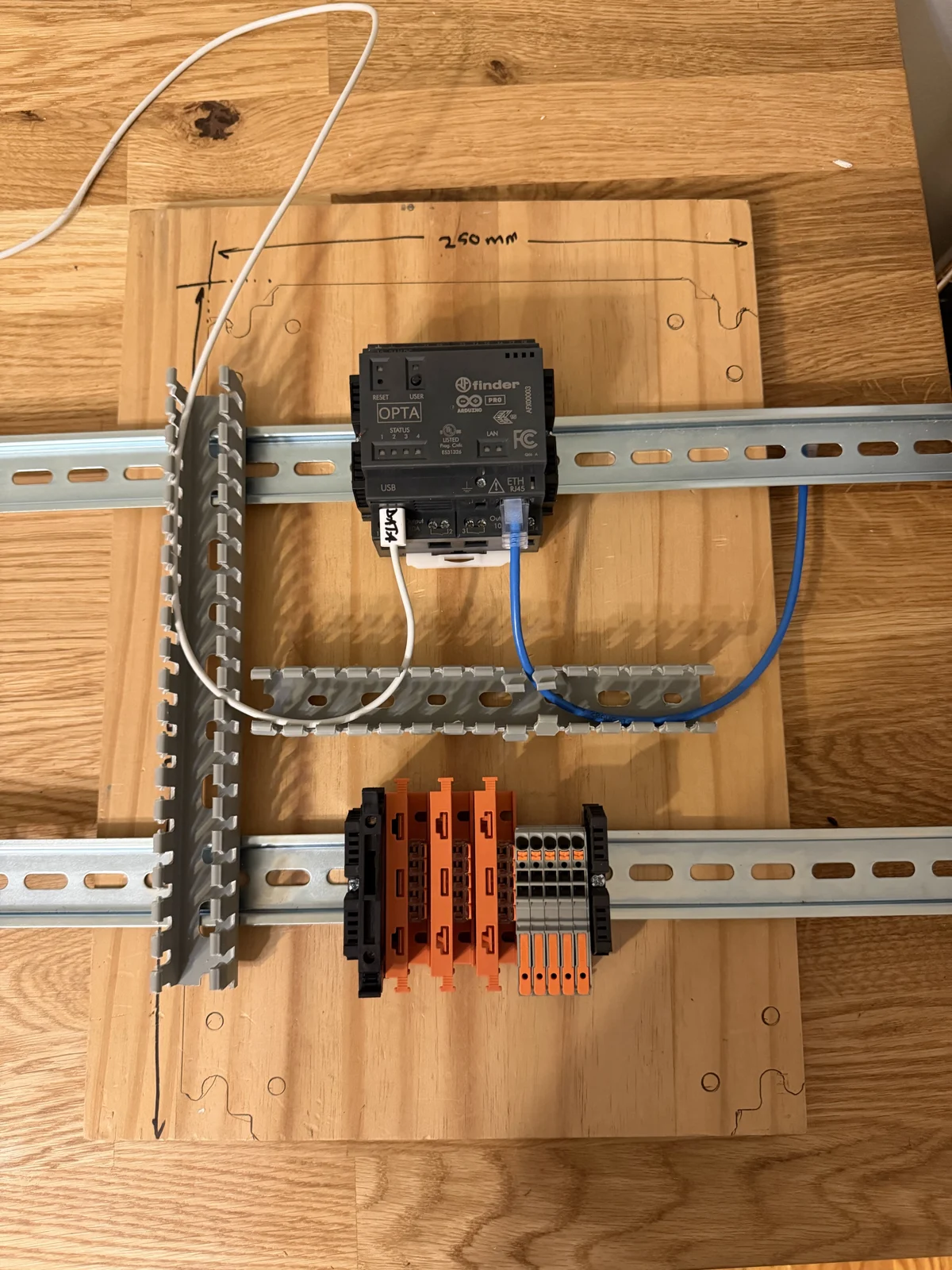 Controller, long rails and cable duct laid out on a wooden template