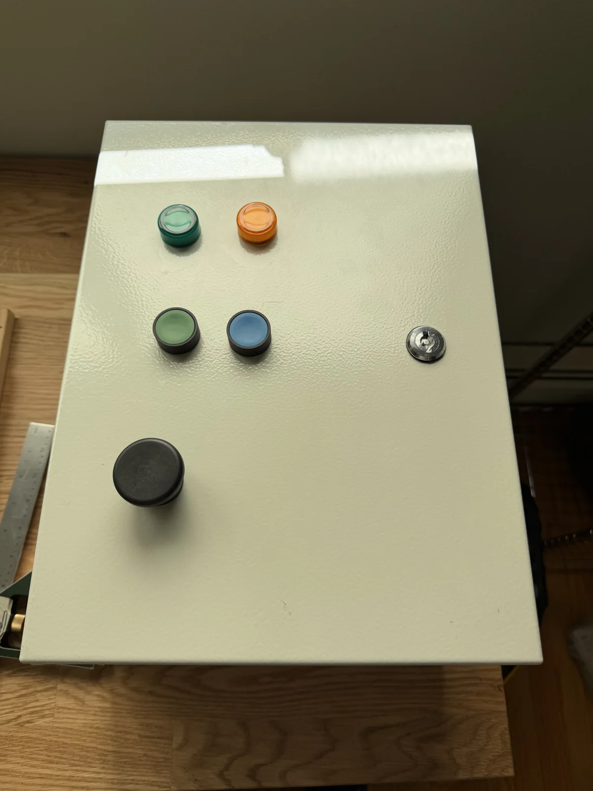 Cabinet door with green and yellow lamps and three buttons installed