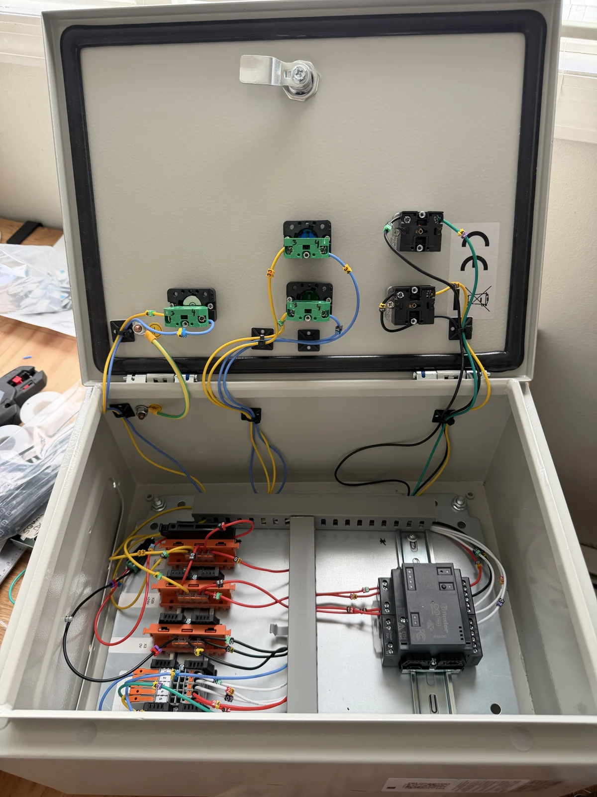 Open cabinet showing wiring between the door controls and terminal blocks