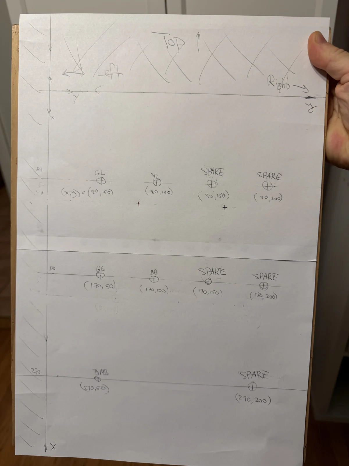 Hand-drawn paper template showing measured lamp and button positions